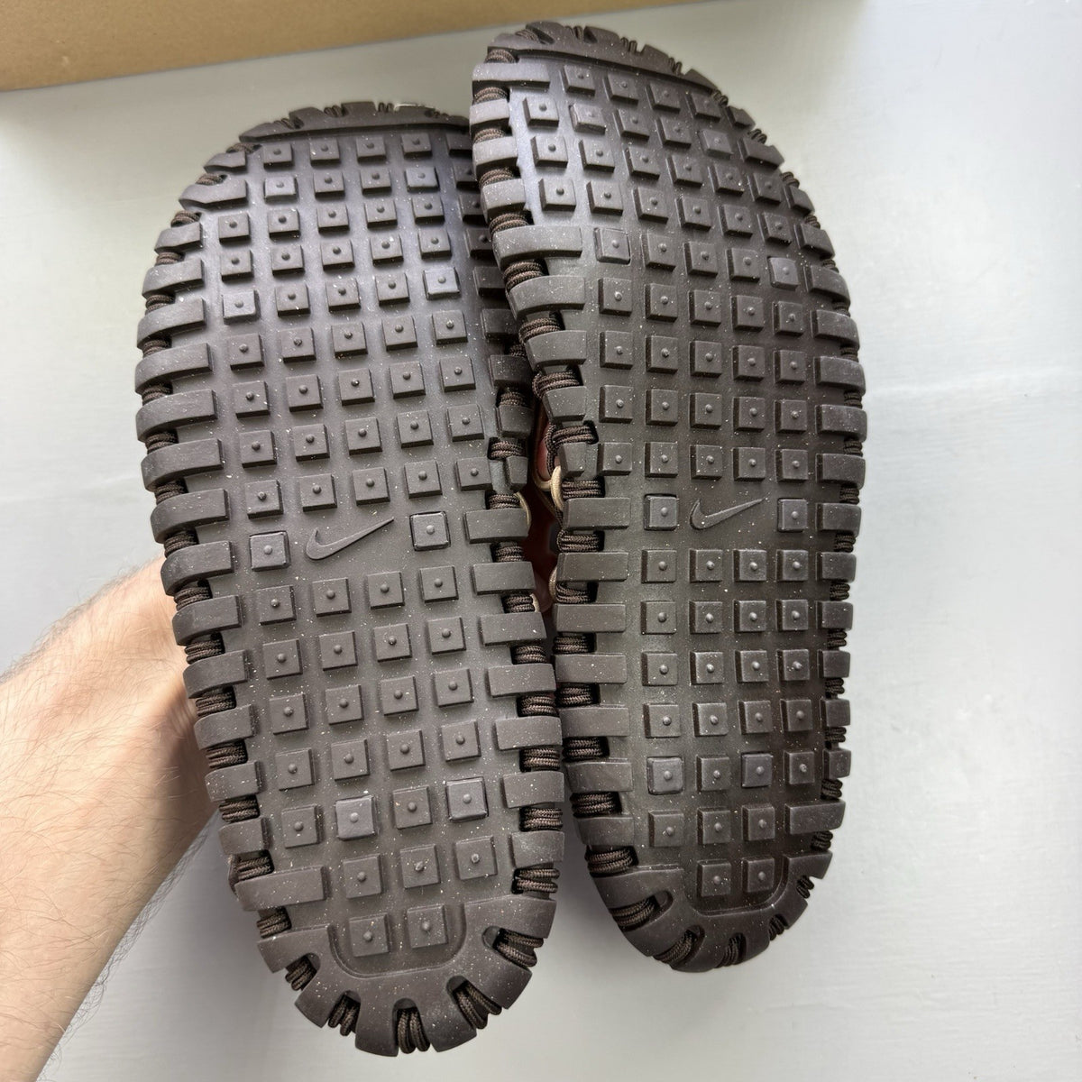 Nike ACG Valkyrie CI slides dark cinder brown with logo detail and textured material.