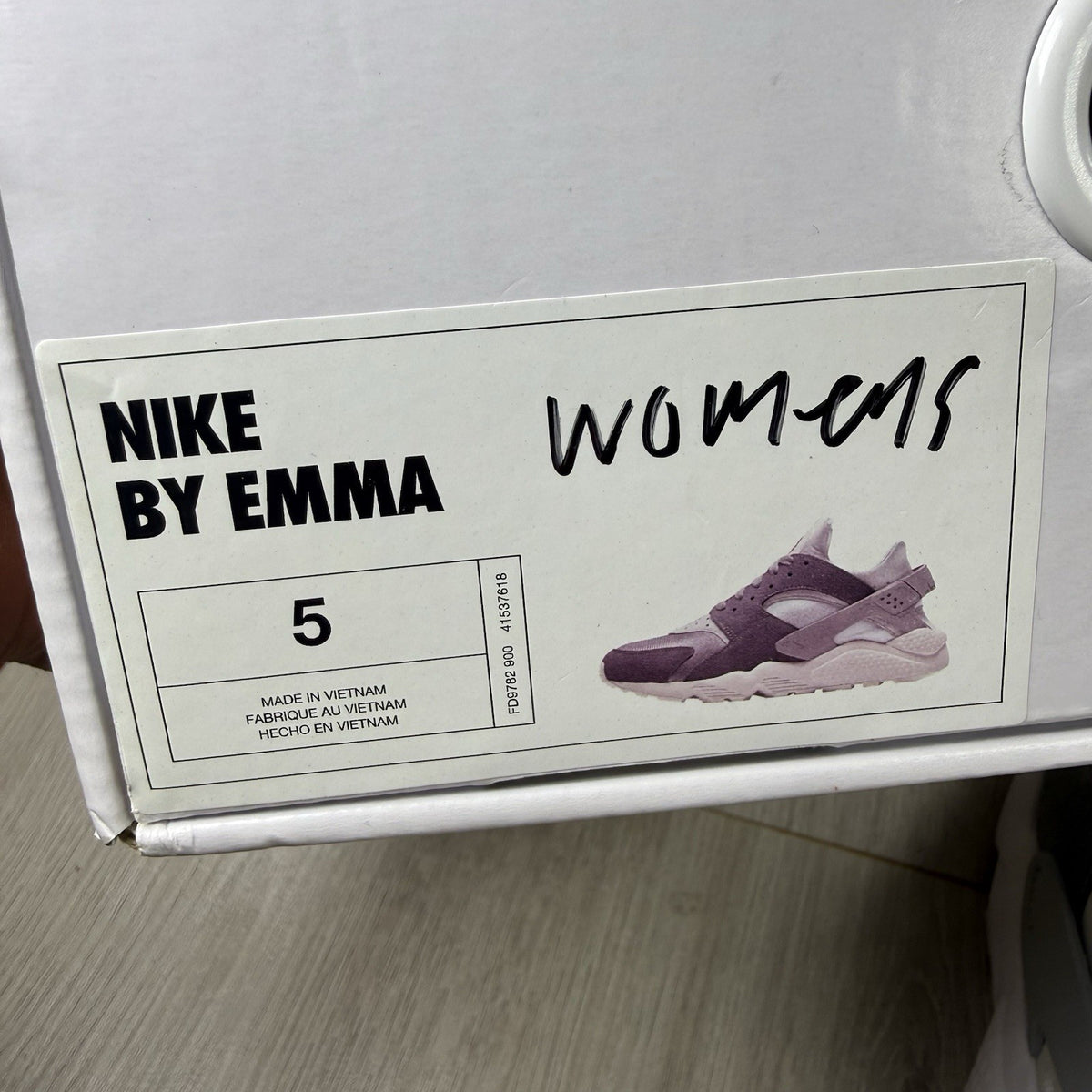 Nike white trainers with grey accents and signature logo on the tongue.