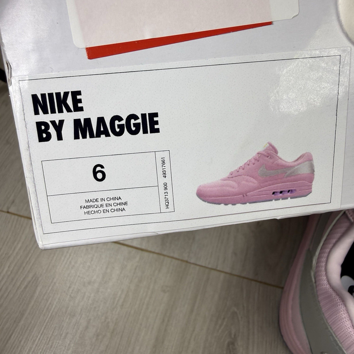 Nike Air Max 1 trainers pink with silver accents and unique design details.