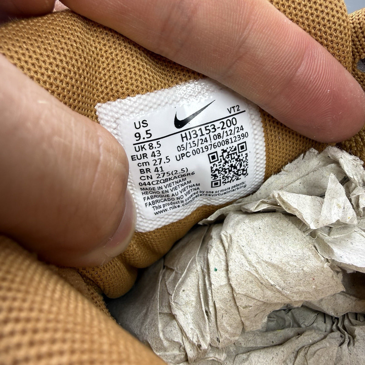 Nike Air Max 90 Premium beige trainers with white accents and textured suede material.