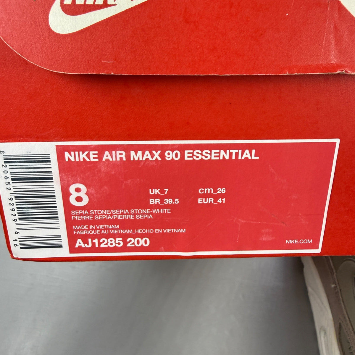 Nike beige trainers with Air Max cushioning and logo detailing.