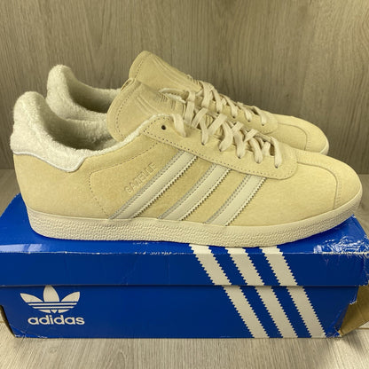 Adidas Gazelle trainers ecru tint with white stripes and suede upper material.
