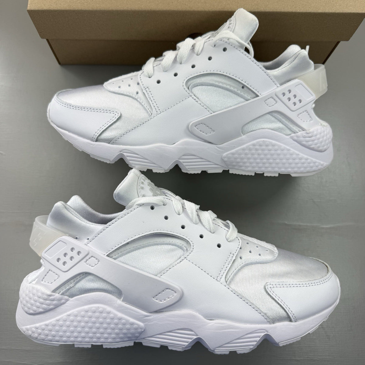 Nike Air Huarache white trainers with Pure Platinum accents and signature logo details.