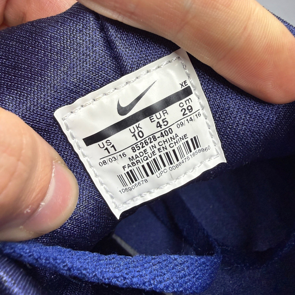 Nike running shoes blue with mesh upper and signature logo detail.