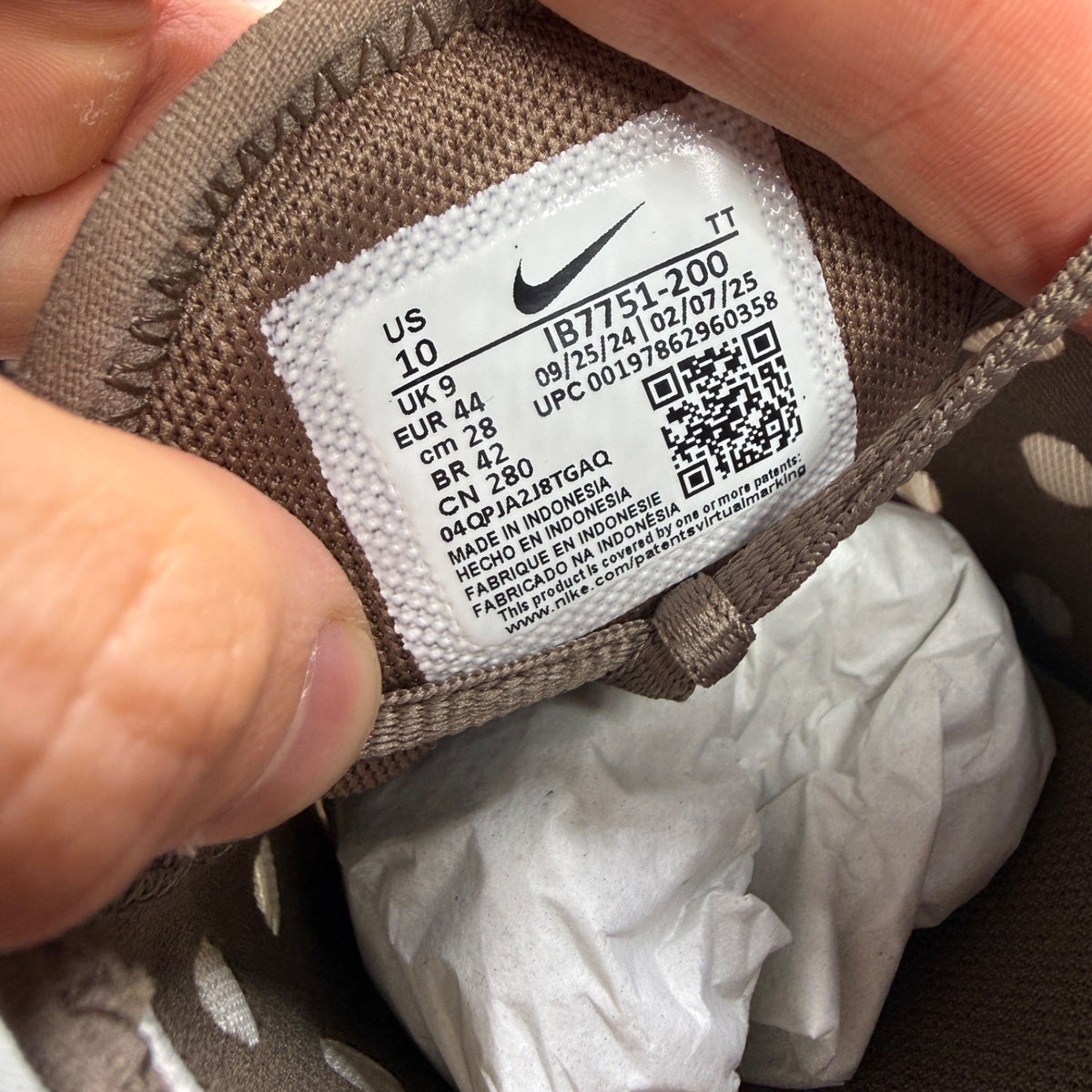 Nike brown trainers with Air Max cushioning and logo detail on the tongue.
