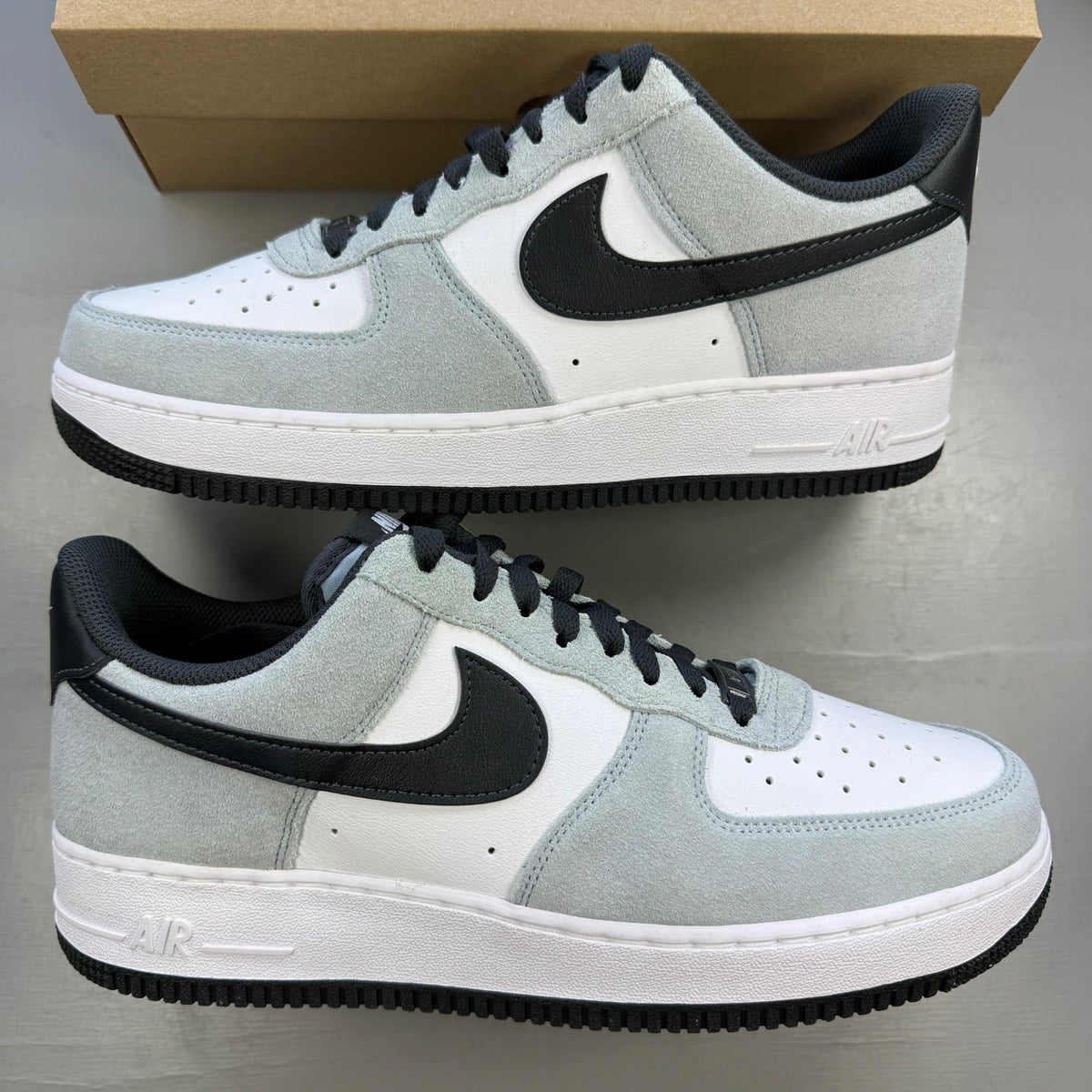 Nike white trainers with Armory Blue accents and signature swoosh logo.