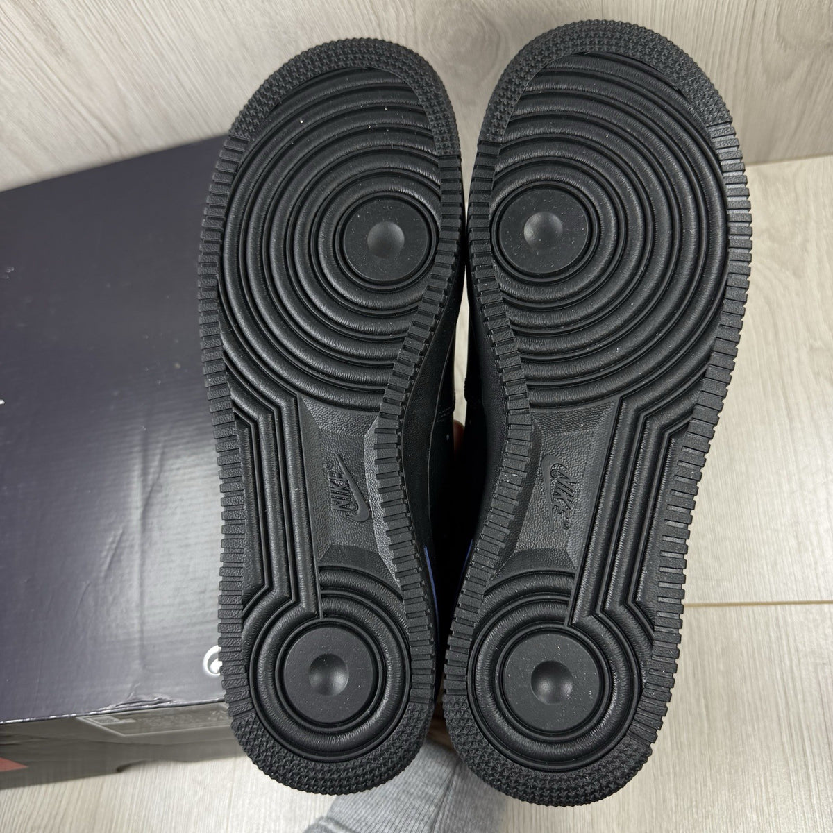 Nike black Air Force 1 Low trainers with jewel swoosh logo and grey accents.
