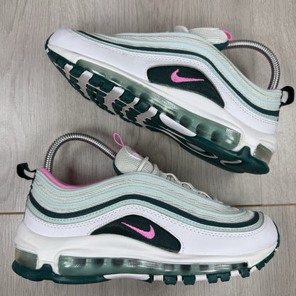 Nike Air Max 97 white trainers with teal accents and reflective detailing.