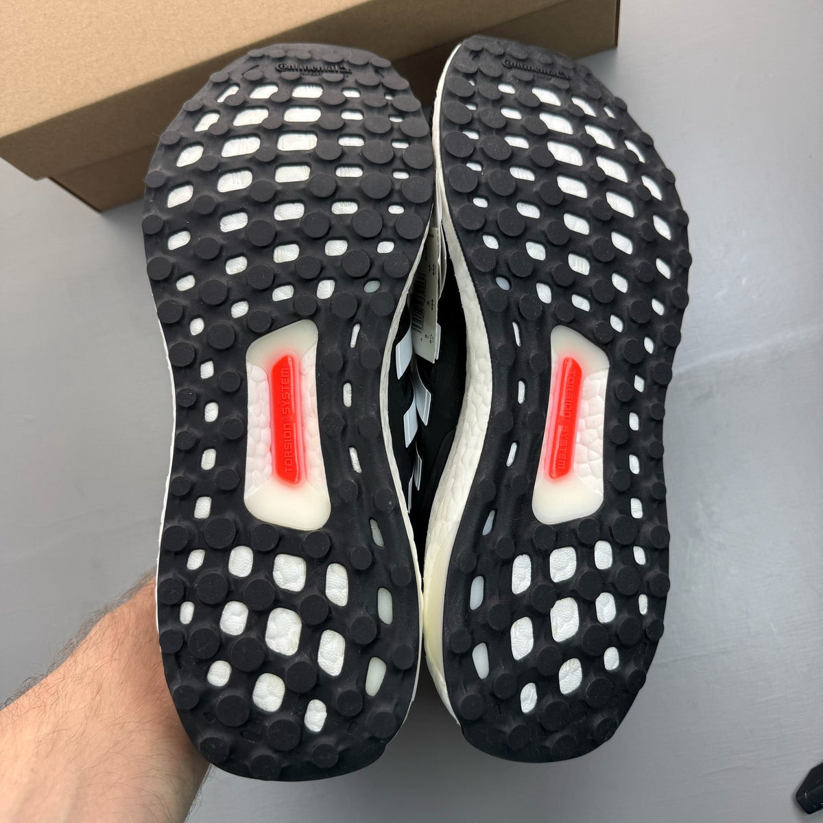 Adidas black Ultra Boost 5.0 trainers with white accents and logo detailing.