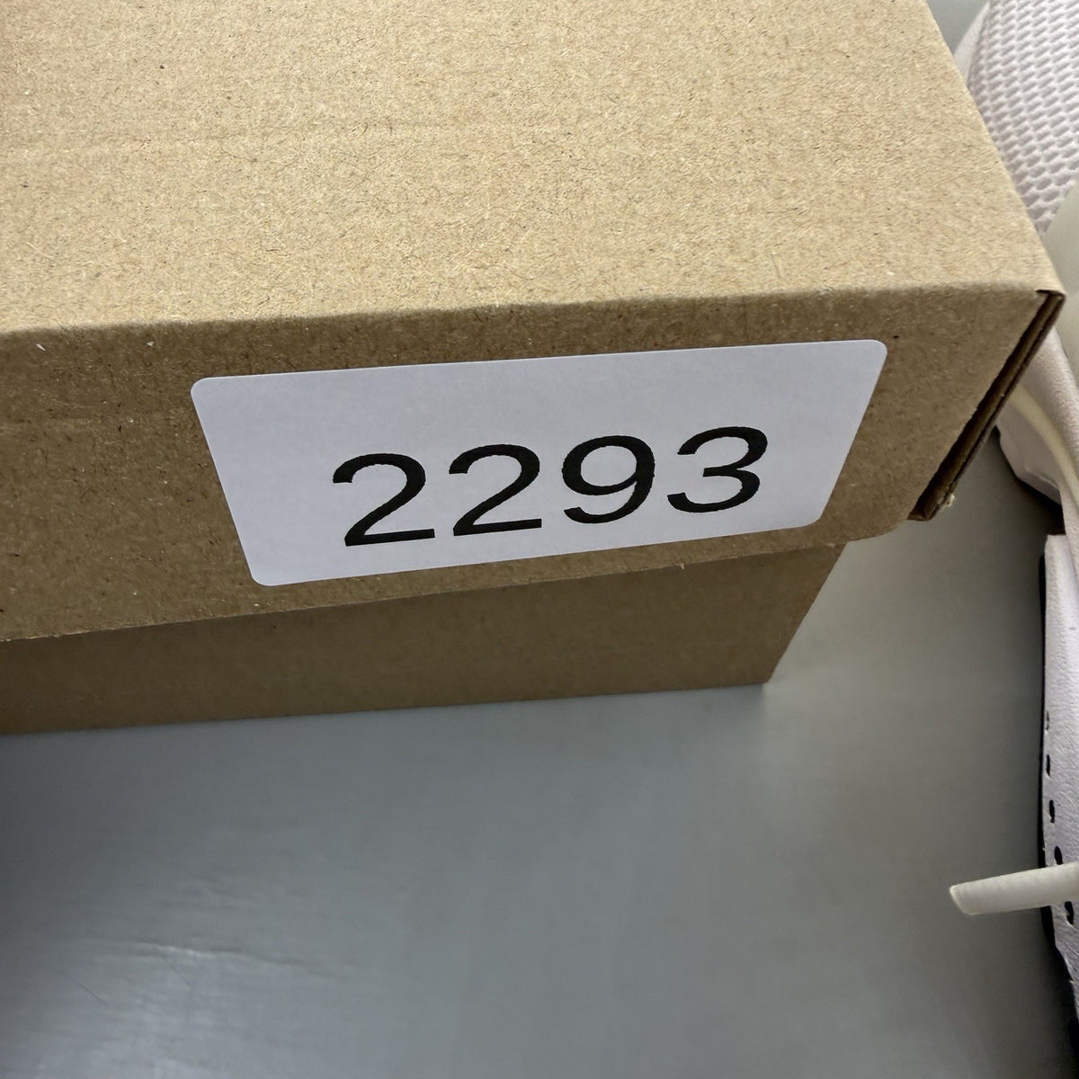Nike Air Presto white trainers with black accents and mesh upper.