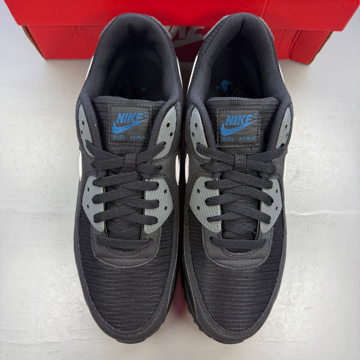 Nike running shoes black with grey accents and logo on the side.