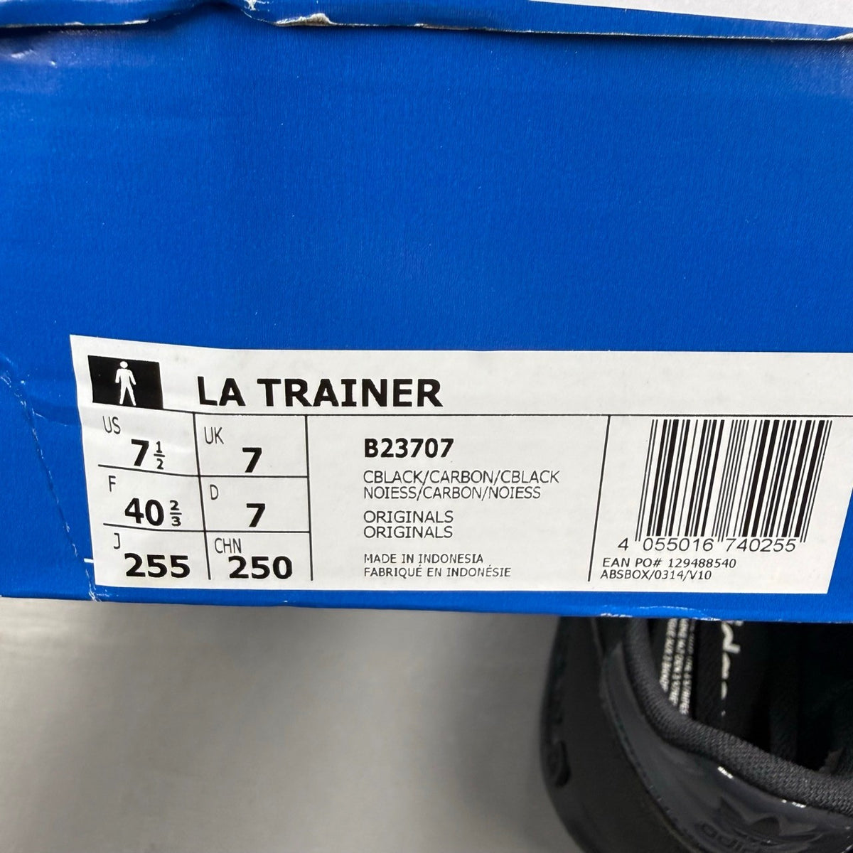 Adidas black deck shoes with three stripes logo and textured upper.