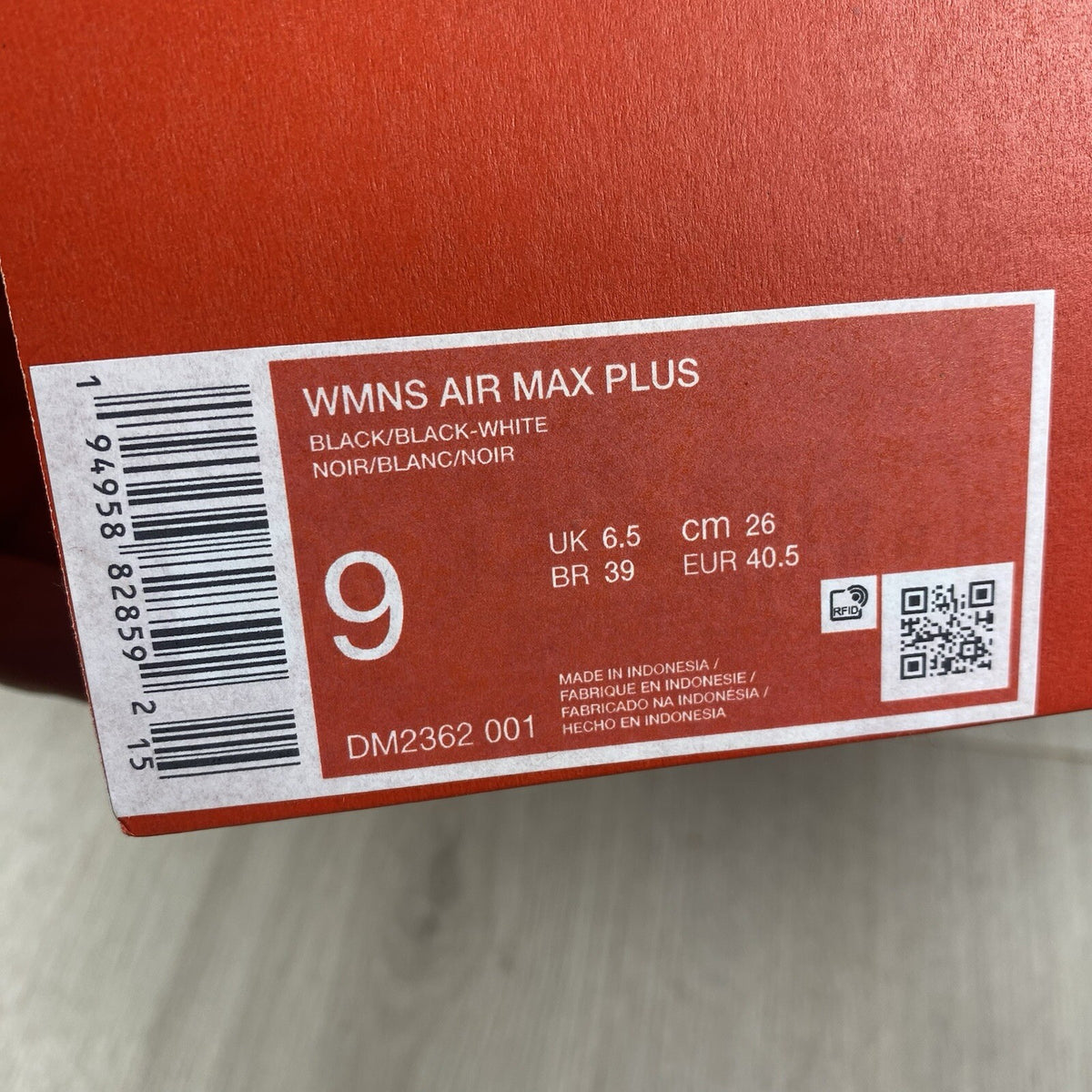 Nike Air Max Plus TN trainers black and white with signature logo and mesh detailing.