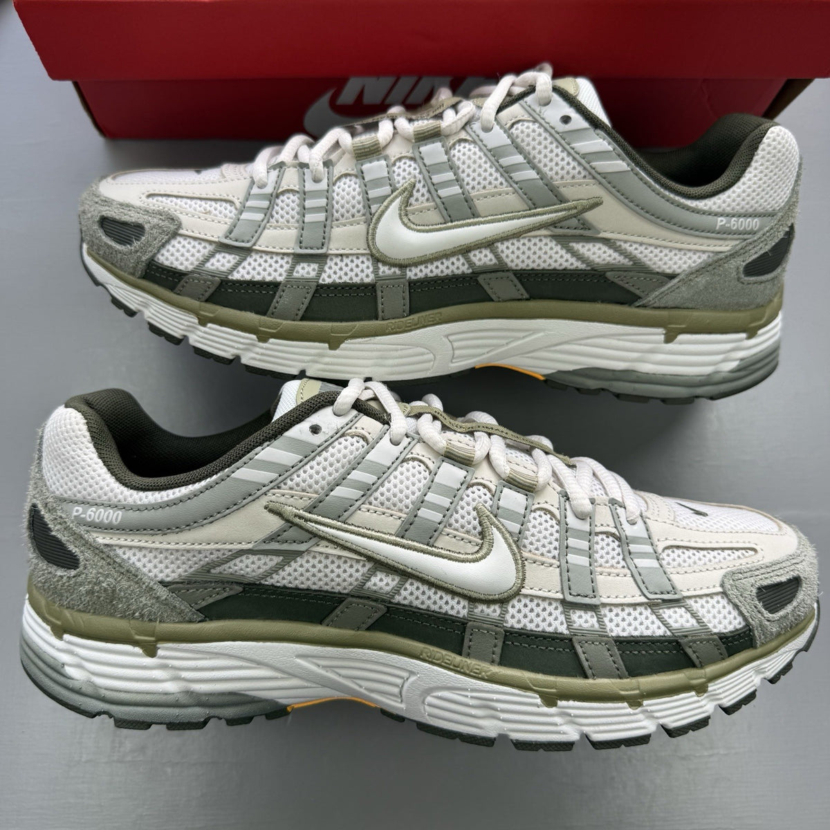 Nike white trainers with light army accents and breathable mesh upper.