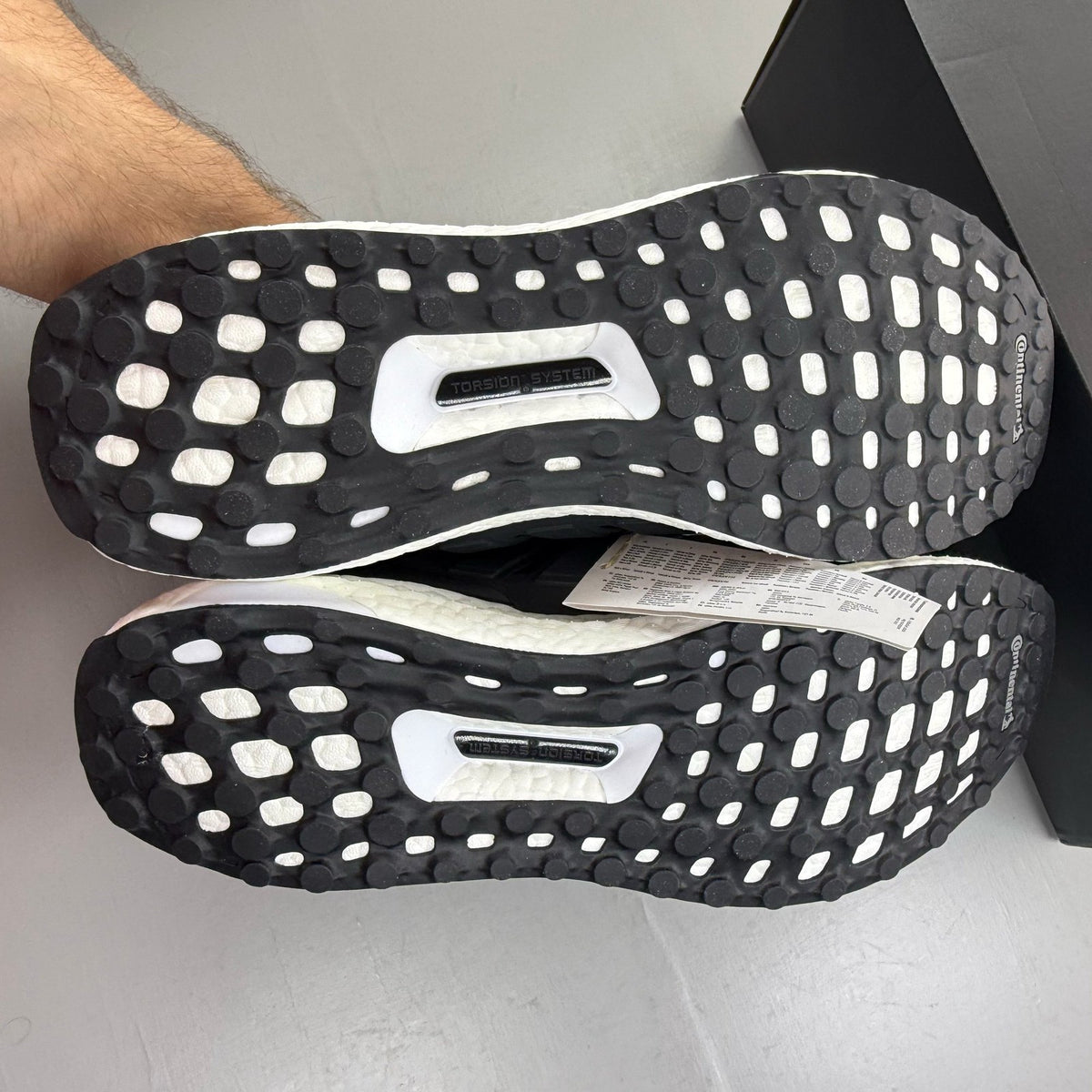 Adidas black Ultra Boost trainers with white accents and signature three-stripe logo.