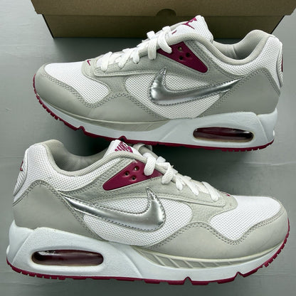 Nike Air Max Correlate white trainers with fuchsia accents and logo detailing.