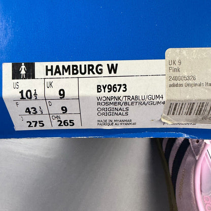 Adidas pink trainers with gum sole, featuring iconic three stripes logo.
