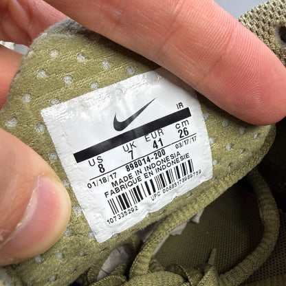 Nike trainers green with Air Max Plus design and signature logo details.
