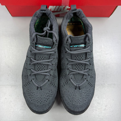 Nike athletic shoes grey Flyknit upper with Air VaporMax sole and logo detail.