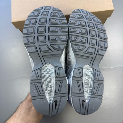 Nike Air Max Torch 4 grey and white trainers with mesh upper and signature swoosh logo.