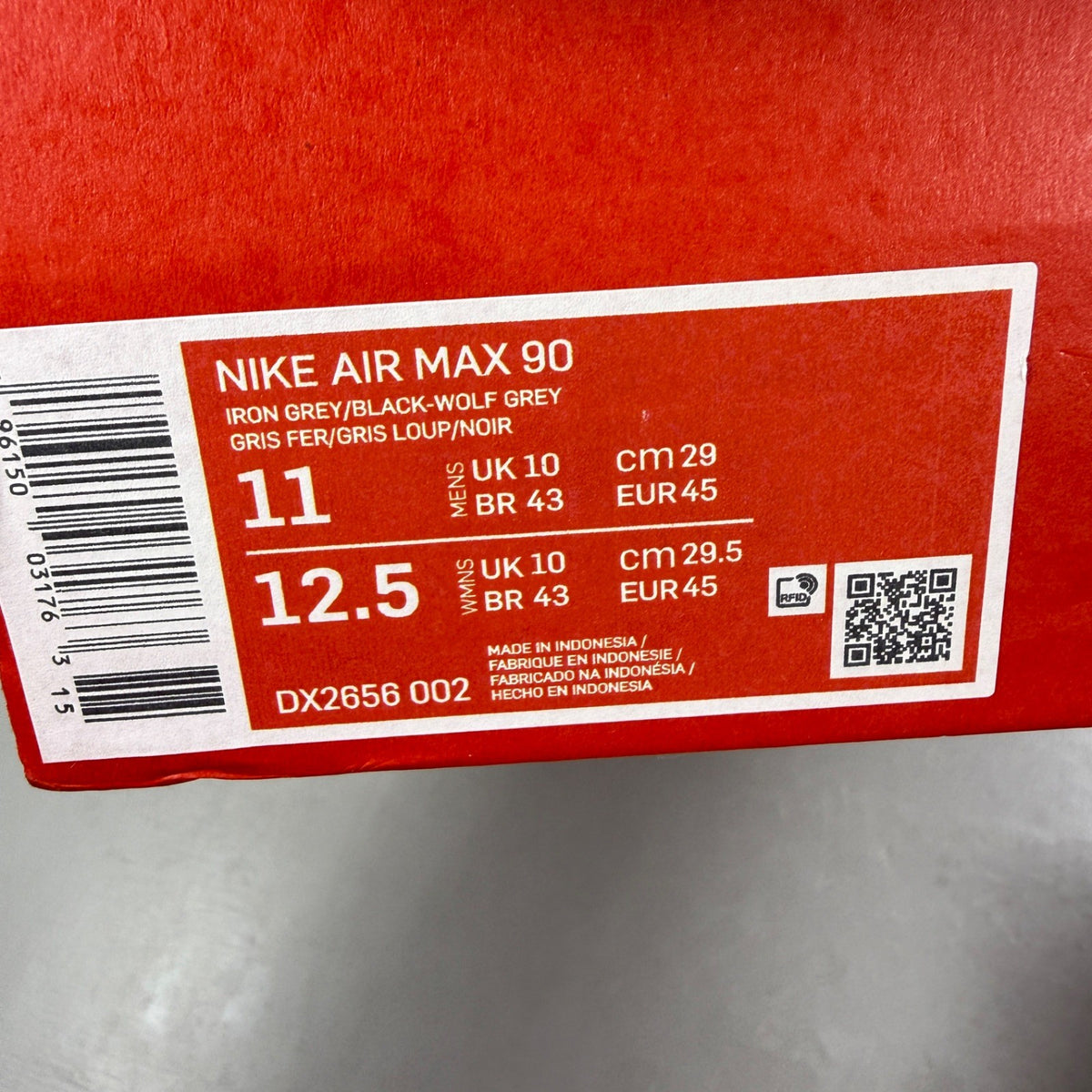 Nike Air Max 90 grey trainers with jewel accents and textured upper.