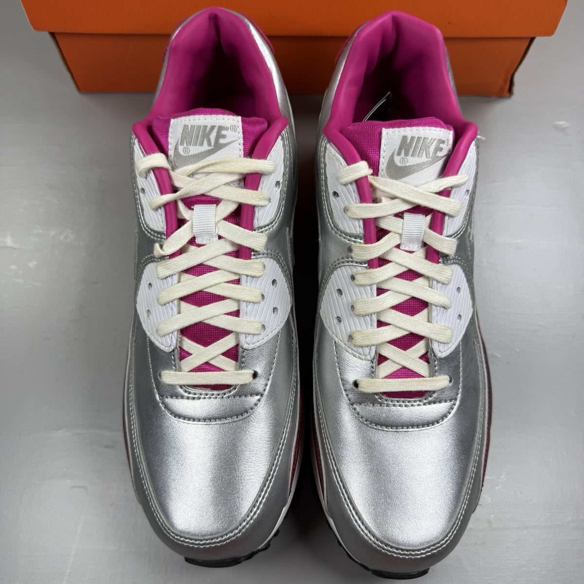 Nike Air Max 90 Premium silver trainers with airbrush finish and signature swoosh logo.