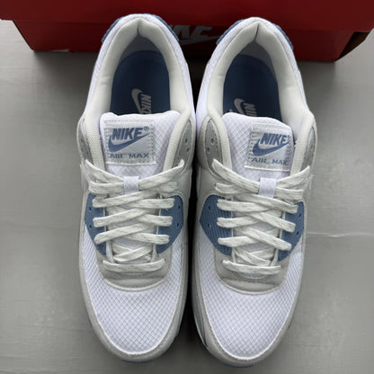 Nike Air Max 90 white trainers with light smoke grey and blue accents, logo on tongue.
