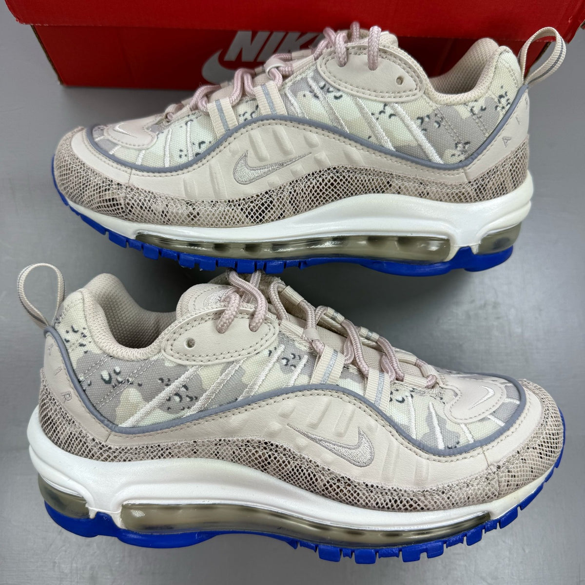 Nike Air Max 98 grey trainers with snakeskin camo pattern and logo detail.
