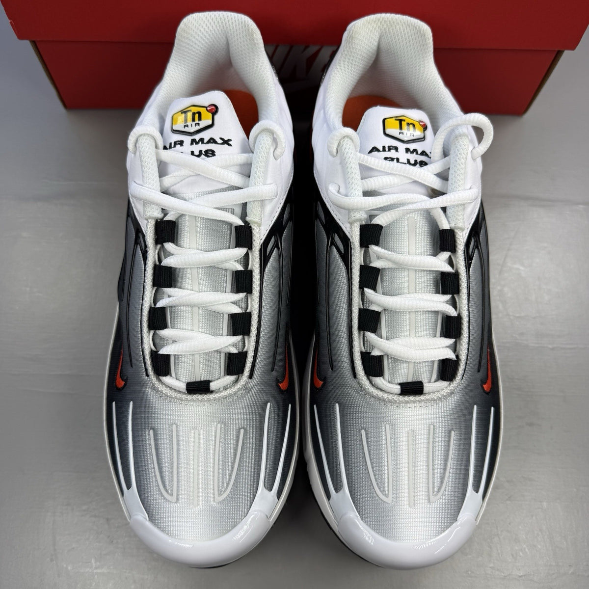 Nike Air Max Plus TN 3 white trainers with black and team orange accents, logo detail.