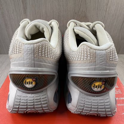 Nike Air Max DN trainers white with light brown accents and logo detail.