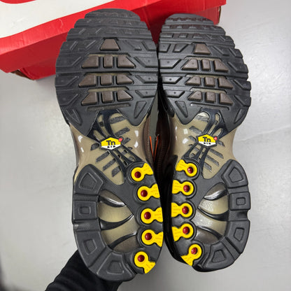 Nike Air Max Plus TN brown athletic shoes with safety orange accents and logo details.