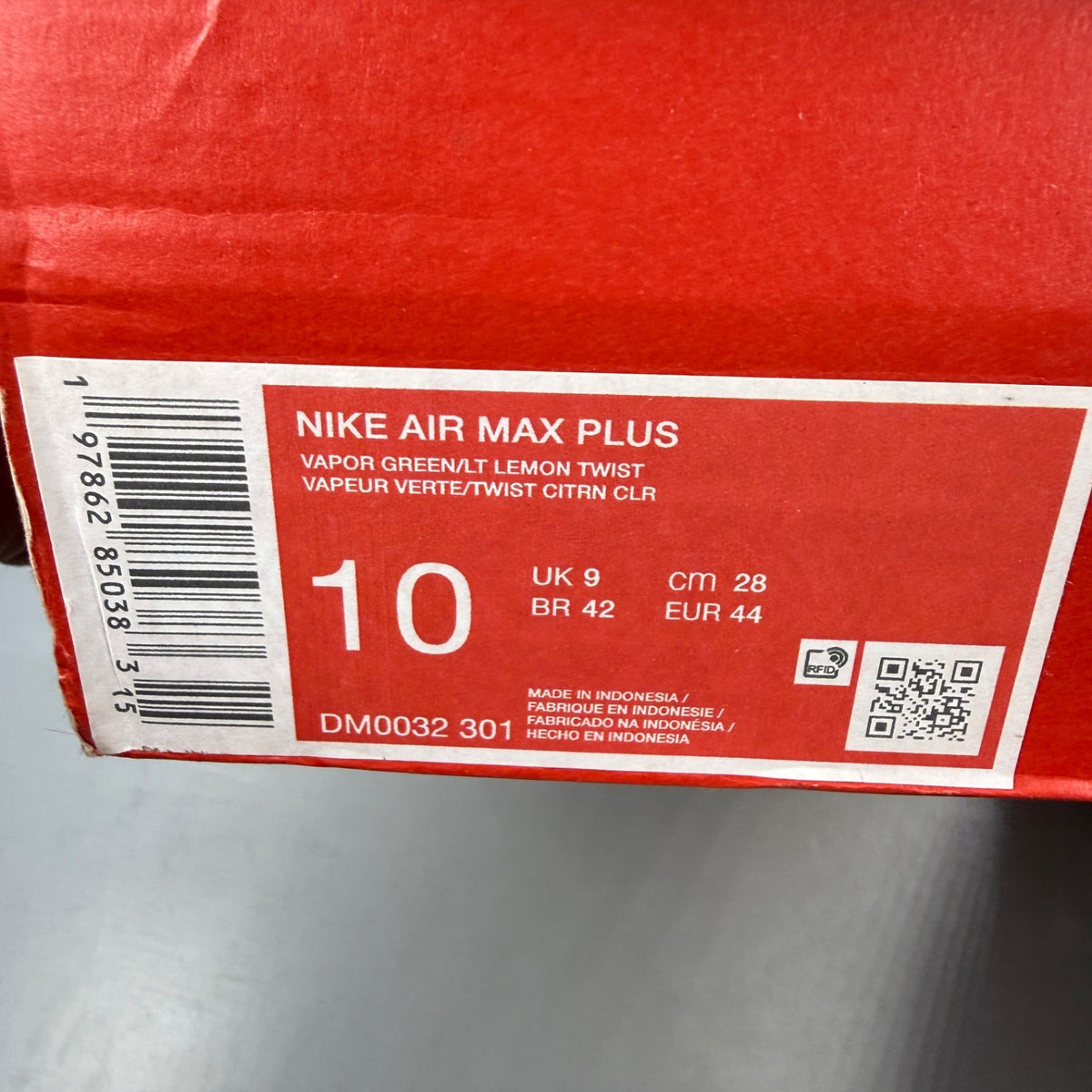 Nike Air Max Plus TN green trainers with logo detailing and mesh material.