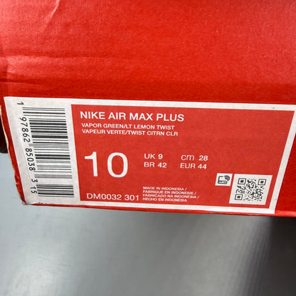 Nike Air Max Plus TN green trainers with logo detailing and mesh material.