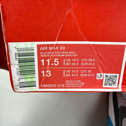 Nike Air Max 90 grey trainers with blue accents and signature swoosh logo.