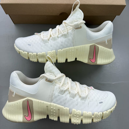 Nike white trainers with mesh upper and subtle branding details.
