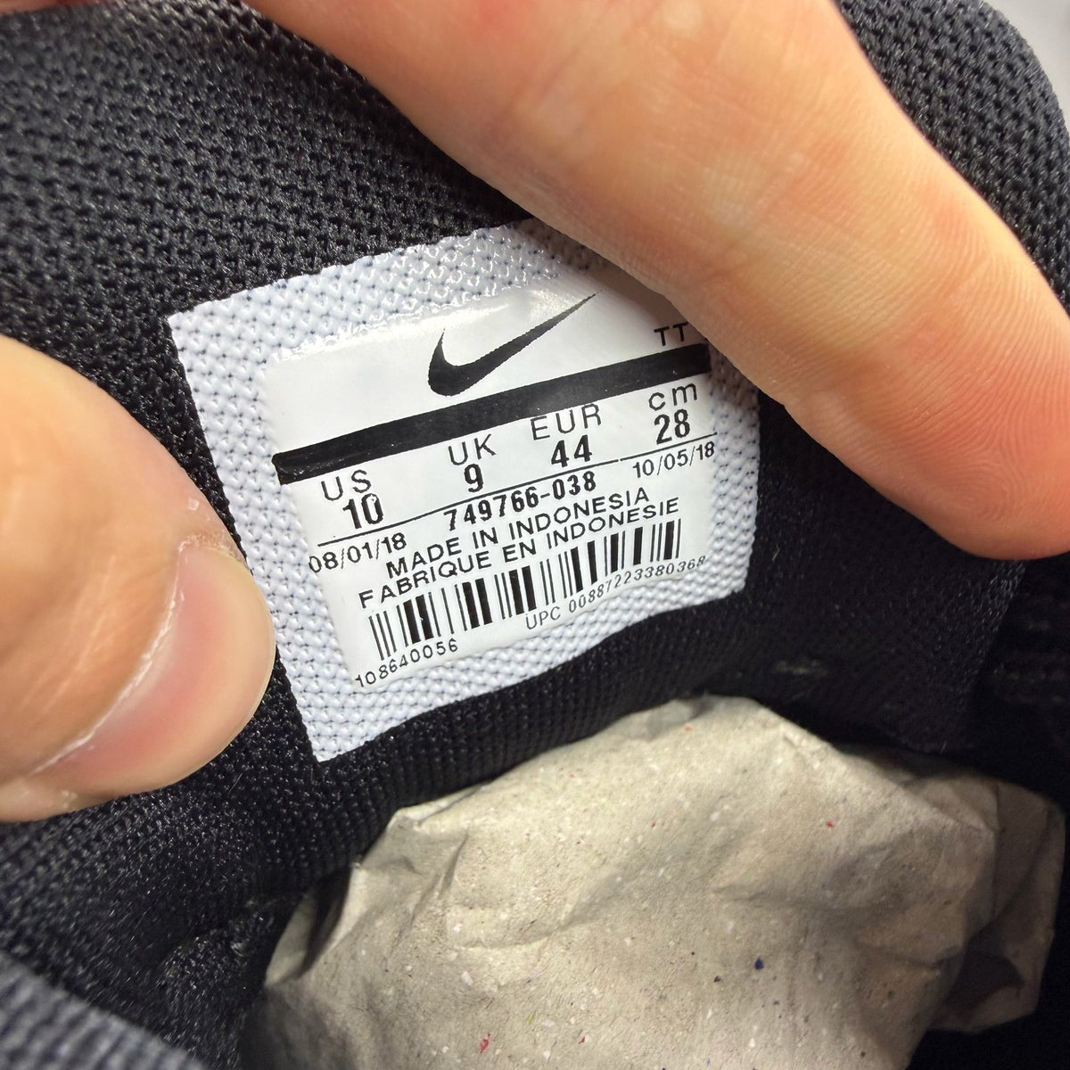 Nike Air Max 95 black trainers with grey and white accents, featuring iconic logo.