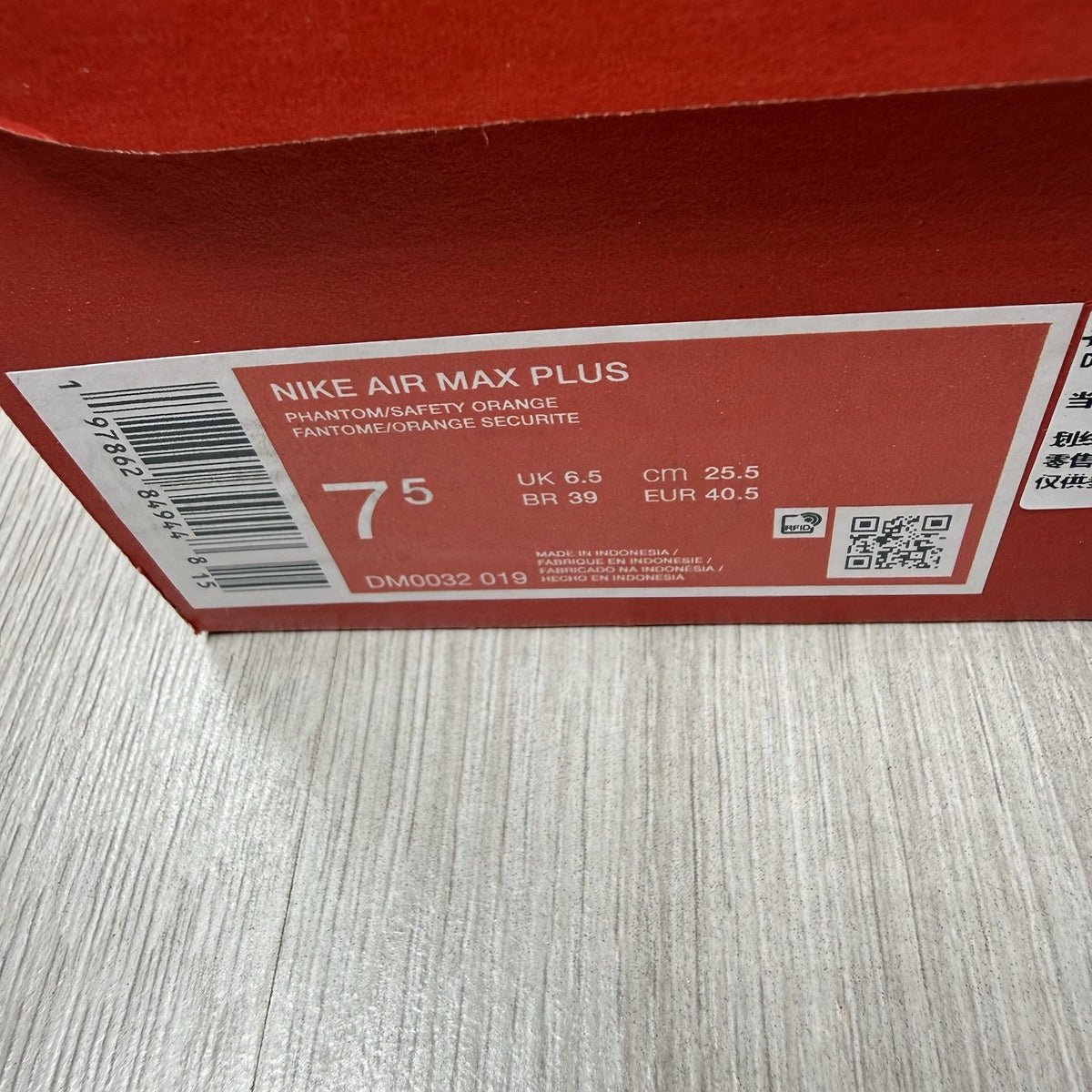 Nike Air Max Plus TN trainers in safety orange with distinctive wave pattern and logo.