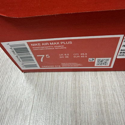 Nike Air Max Plus TN trainers in safety orange with distinctive wave pattern and logo.