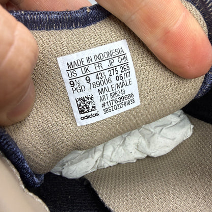 Adidas blue athletic shoes with white accents and textured weave design.