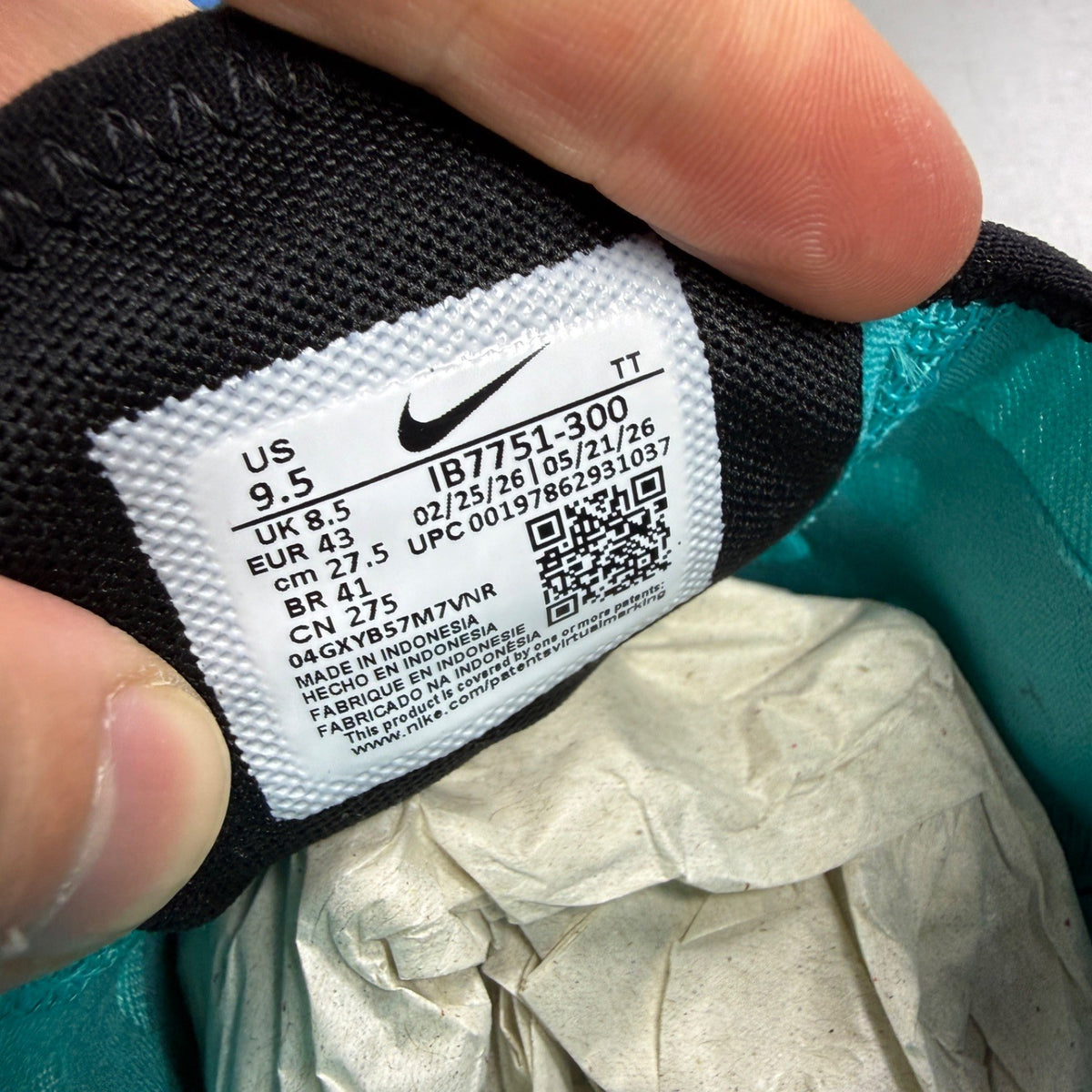 Nike Air Max 270 blue trainers with white accents and logo detailing.