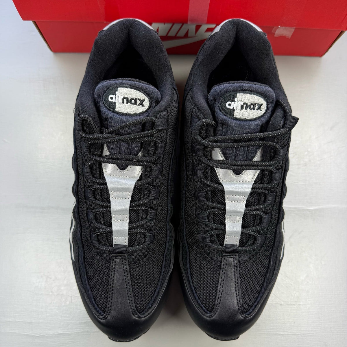 Nike Air Max 95 black trainers with silver accents and signature big bubble sole.