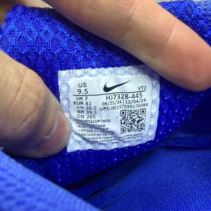 Nike Zoom Vomero 5 blue trainers with silver accents and logo detailing.