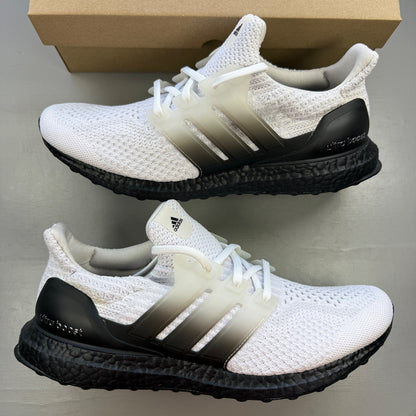 Adidas running shoes white with black accents and Boost cushioning technology.