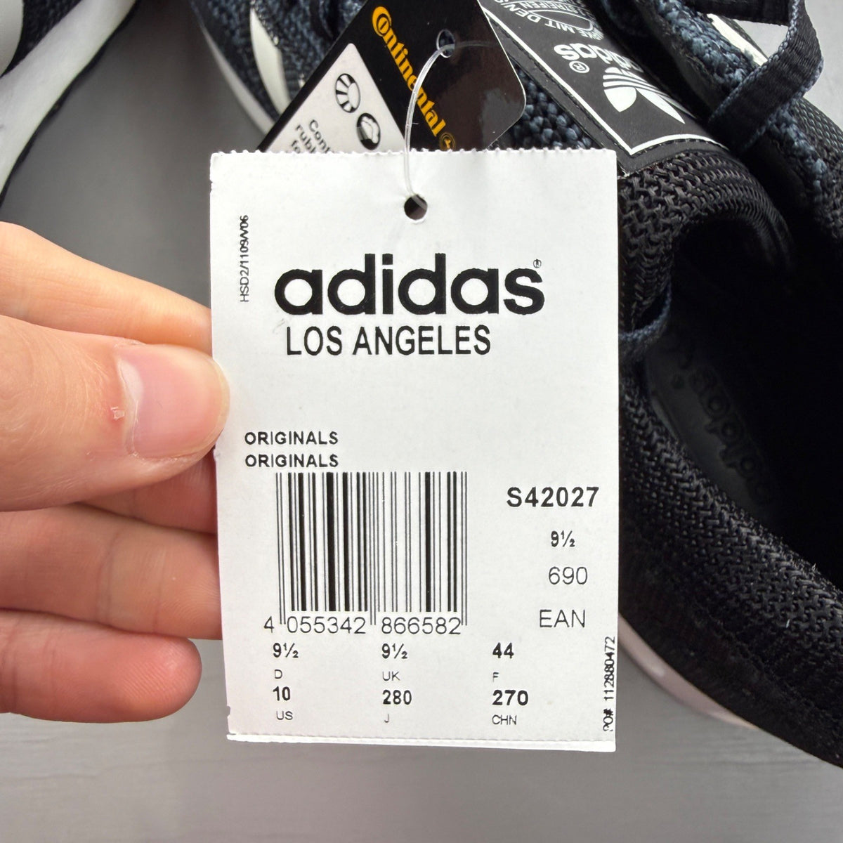 Adidas black deck shoes with white stripes and logo, brand new in box.