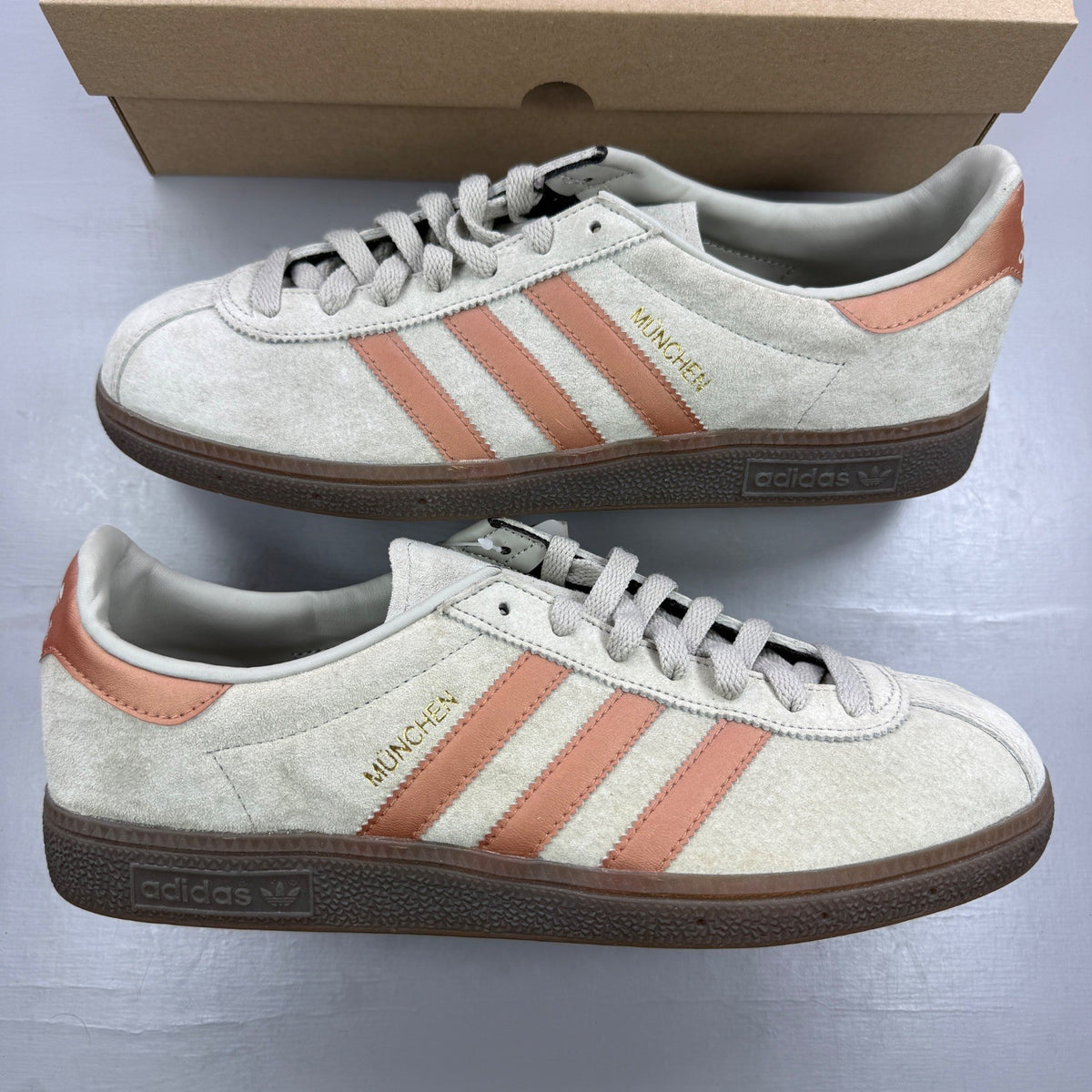 Adidas grey deck shoes with iconic three stripes and textured suede material.
