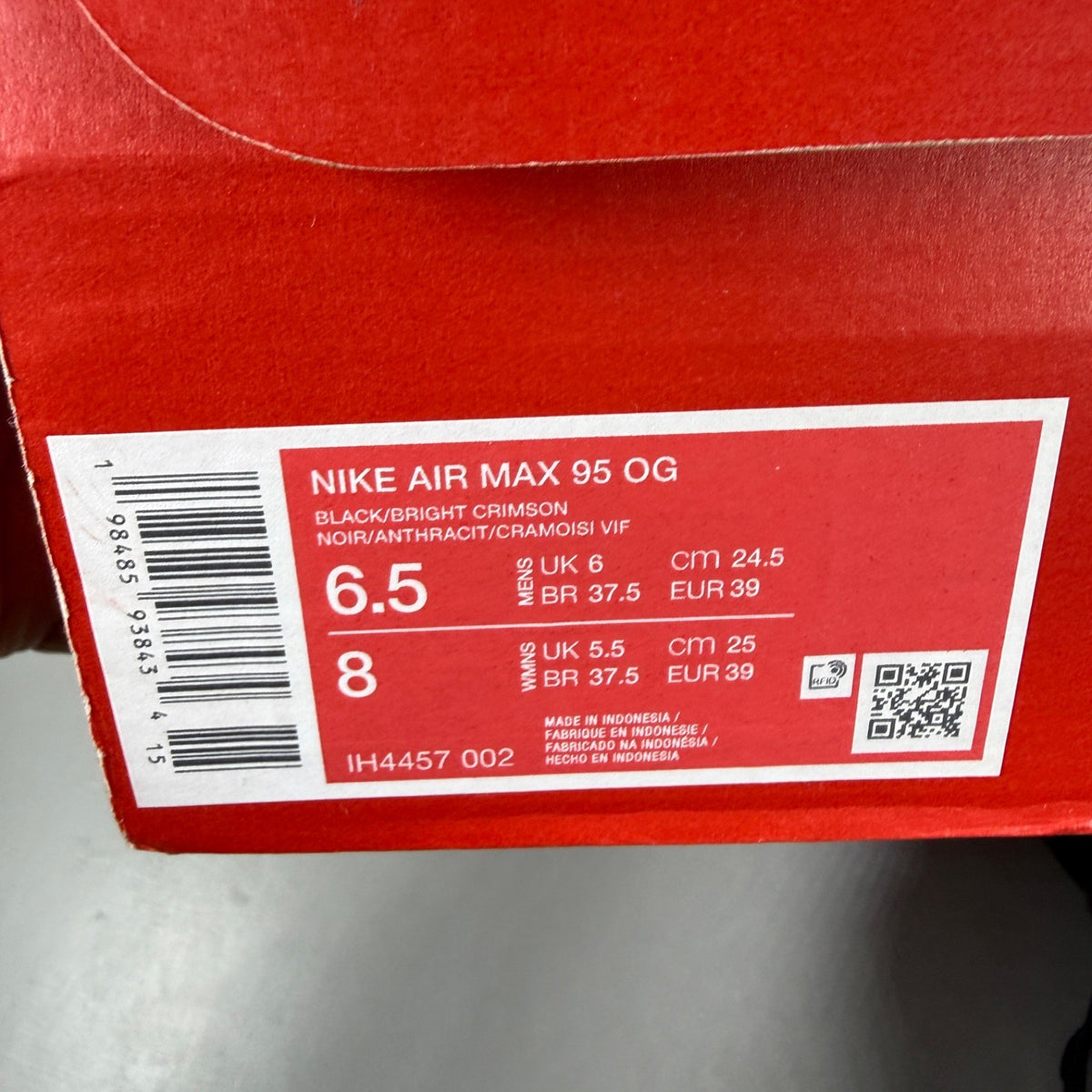 Nike deck shoes black with bright crimson accents and signature logo details.