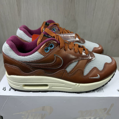 Nike Air Max 1 brown trainers with unique Patta logo and premium suede material.