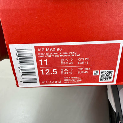 Nike Air Max 90 grey trainers with pink foam accents and white sole.