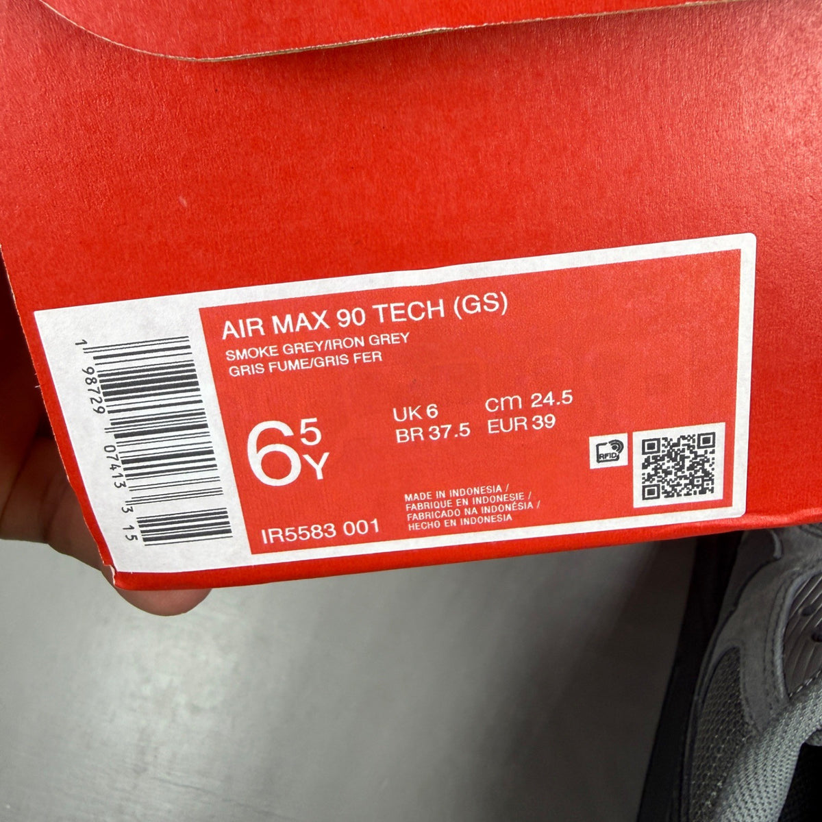 Nike Air Max 90 Tech grey trainers with blue accents and logo detail.