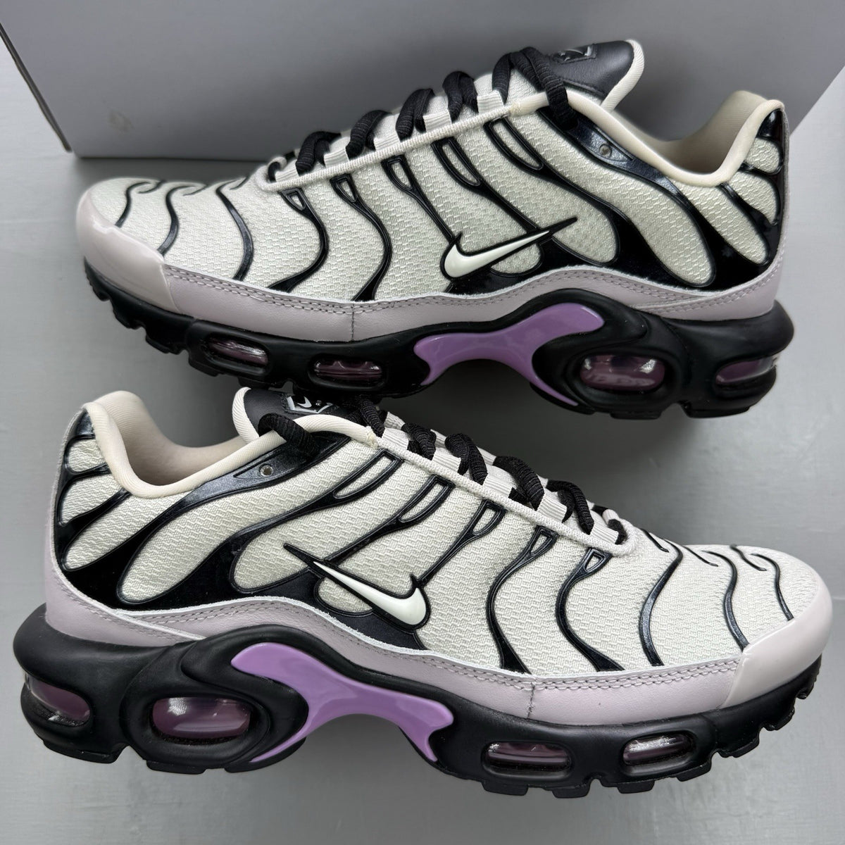 Nike Air Max Plus TN white trainers with black and purple accents, custom writing on bubbles.